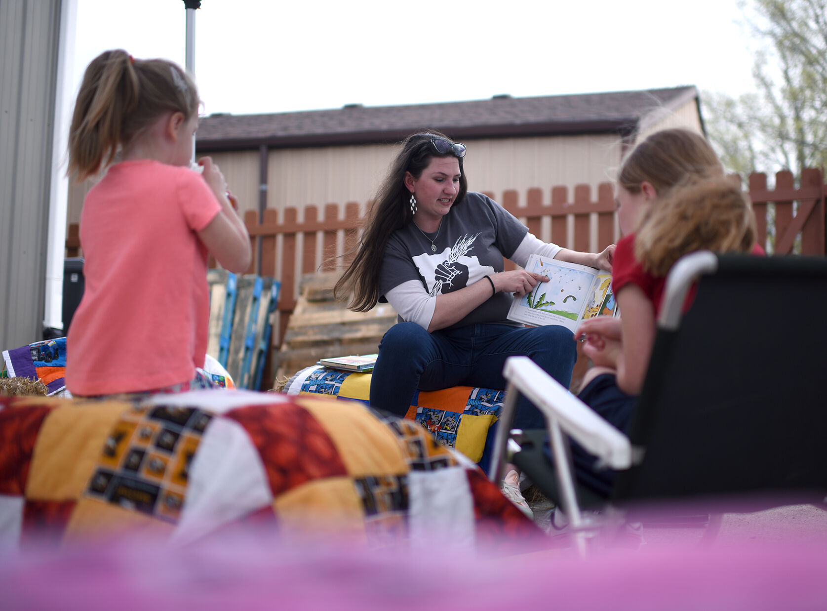 Jamie Blair reads to, from left, Blakely, 4, and Kinley, 7, on Thursday